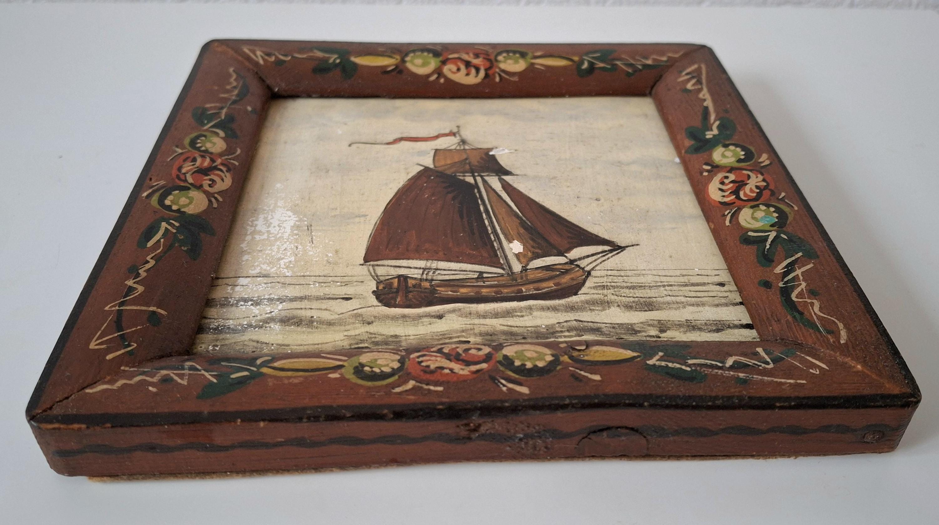 Decorative framed Dutch tile with a sailboat image