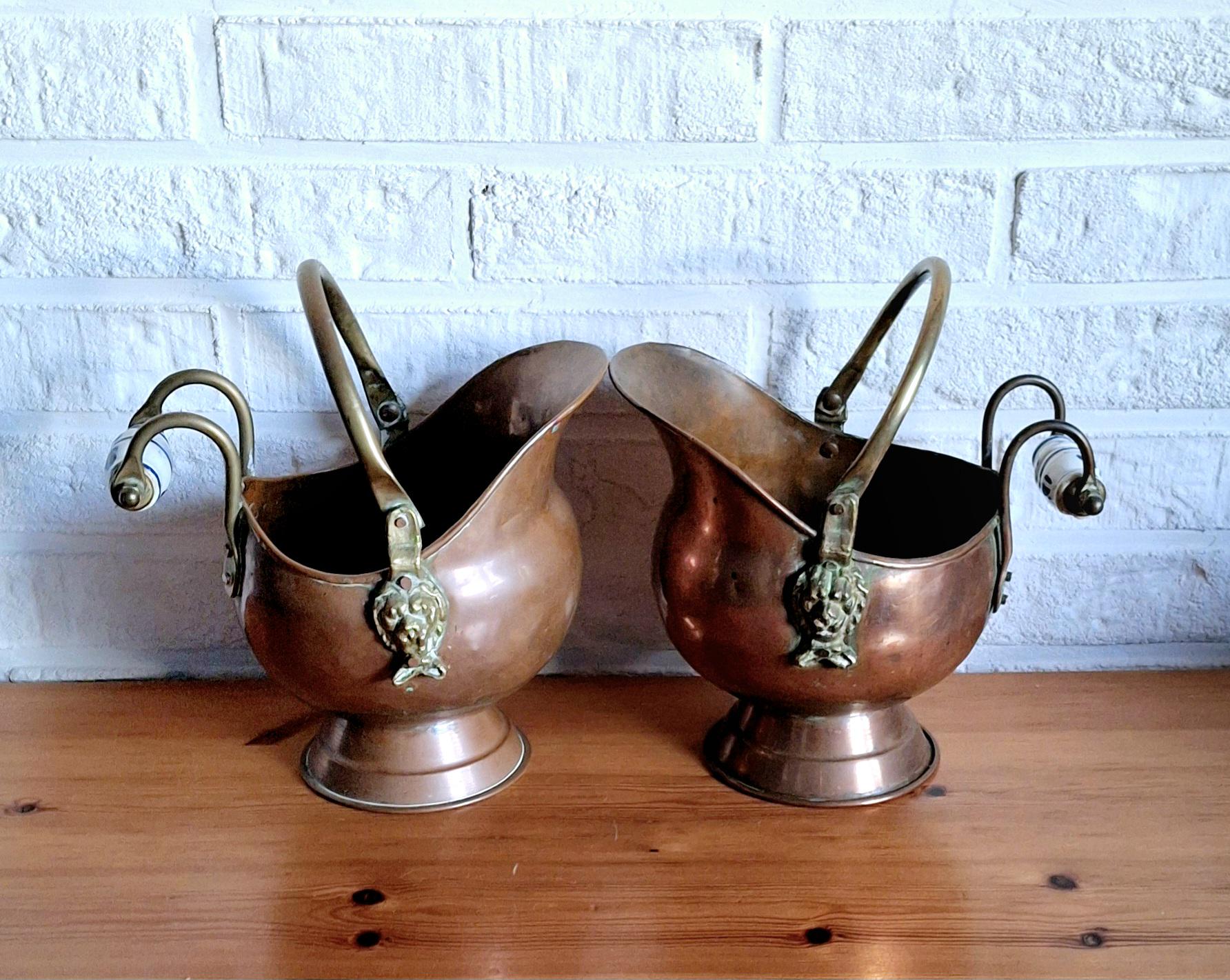 Vintage copper coal scuttle bucket pair with ceramic Delft handles and brass lion head