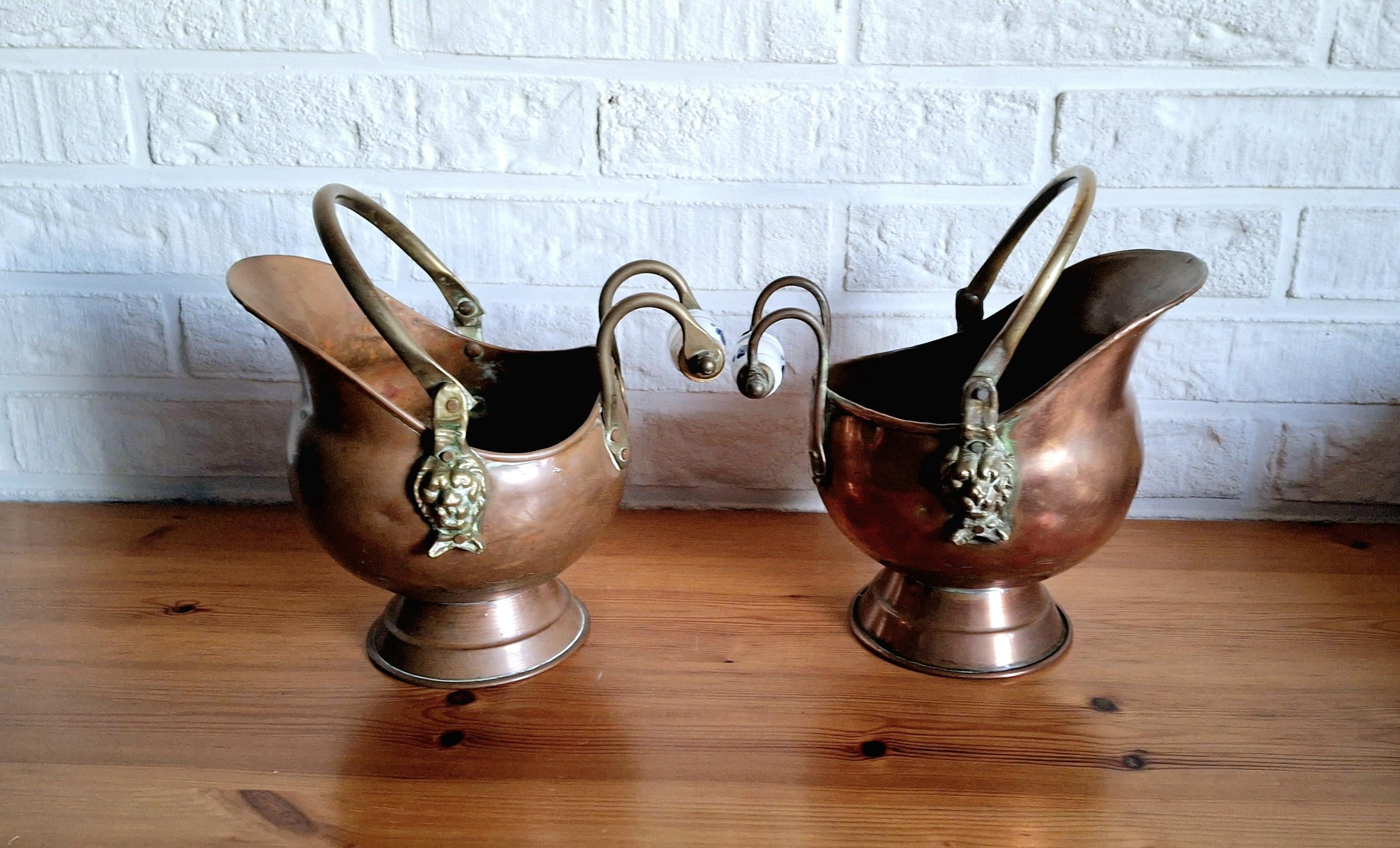 Vintage copper coal scuttle bucket pair with ceramic Delft handles and brass lion head