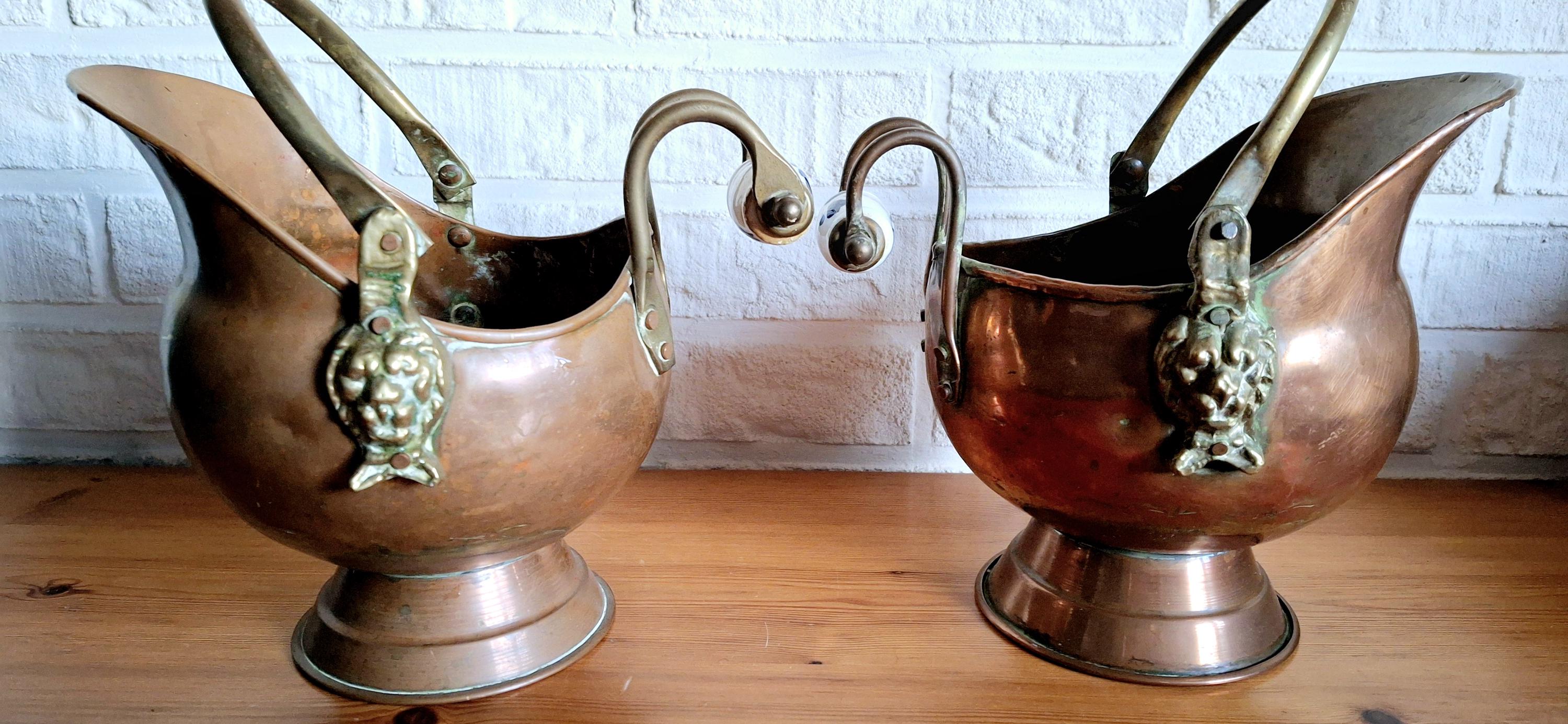 Vintage copper coal scuttle bucket pair with ceramic Delft handles and brass lion head