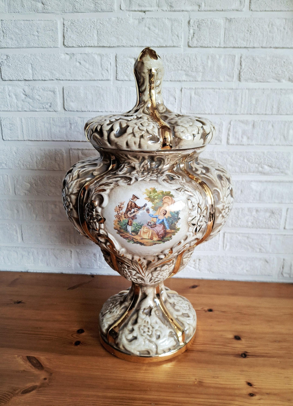 Italian rococo revival lidded vase with floral reliefs and gold accents