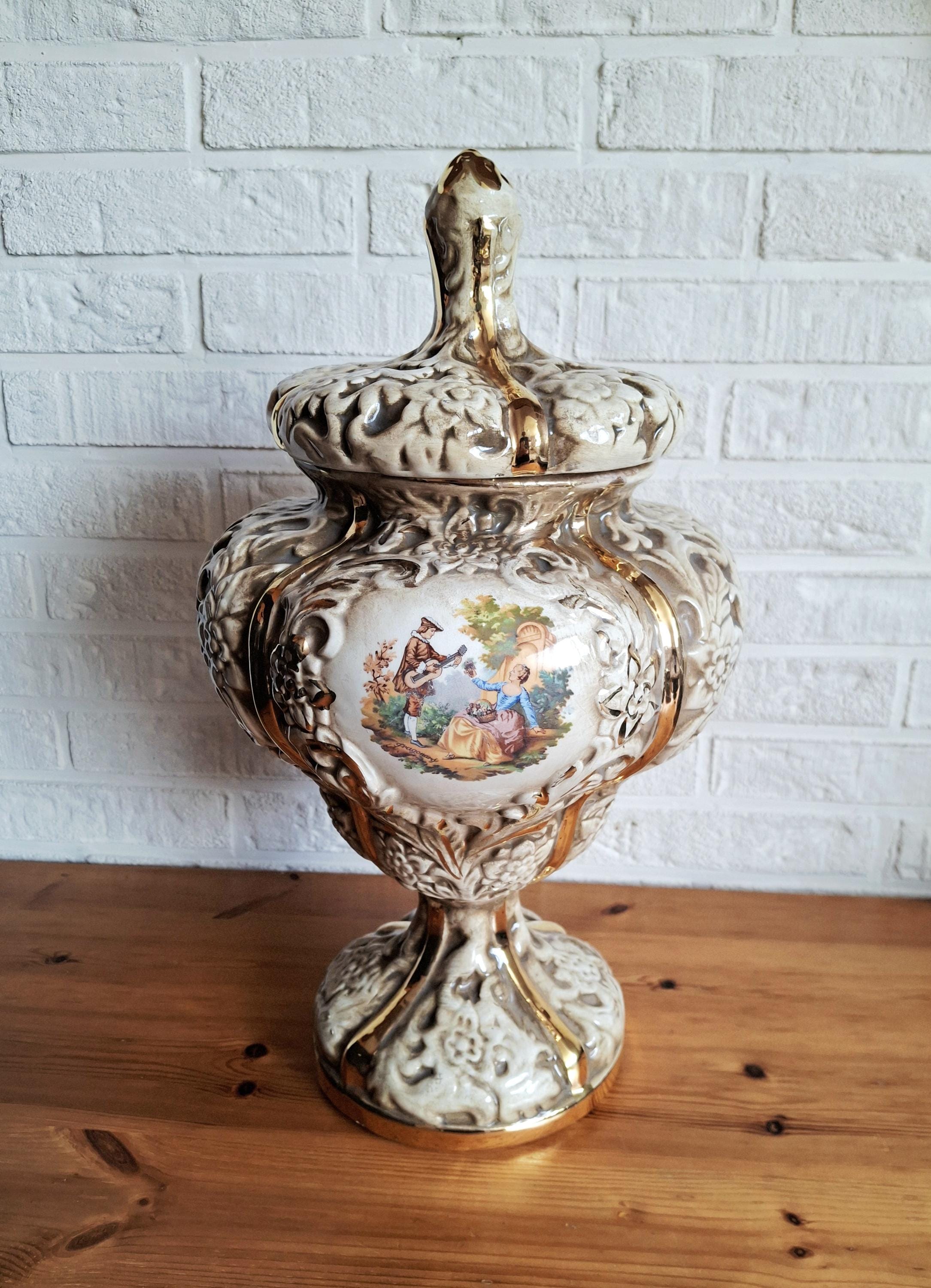 Italian rococo revival lidded vase with floral reliefs and gold accents