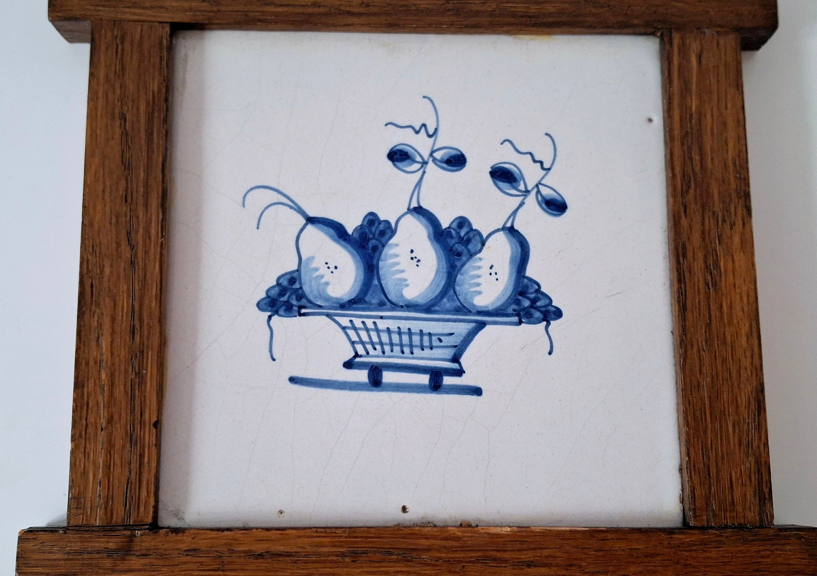 Dutch blue & white decorative tile in oak frame, antique Delft basket of fruit tile
