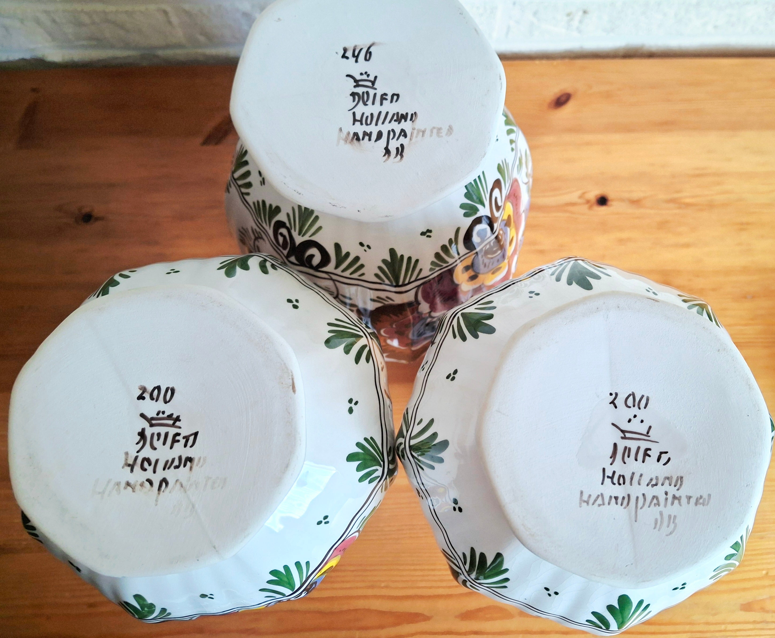 Three hand-painted Delft porcelain vases, cabinet set with colored floral pattern, Delft Earthenware Holland