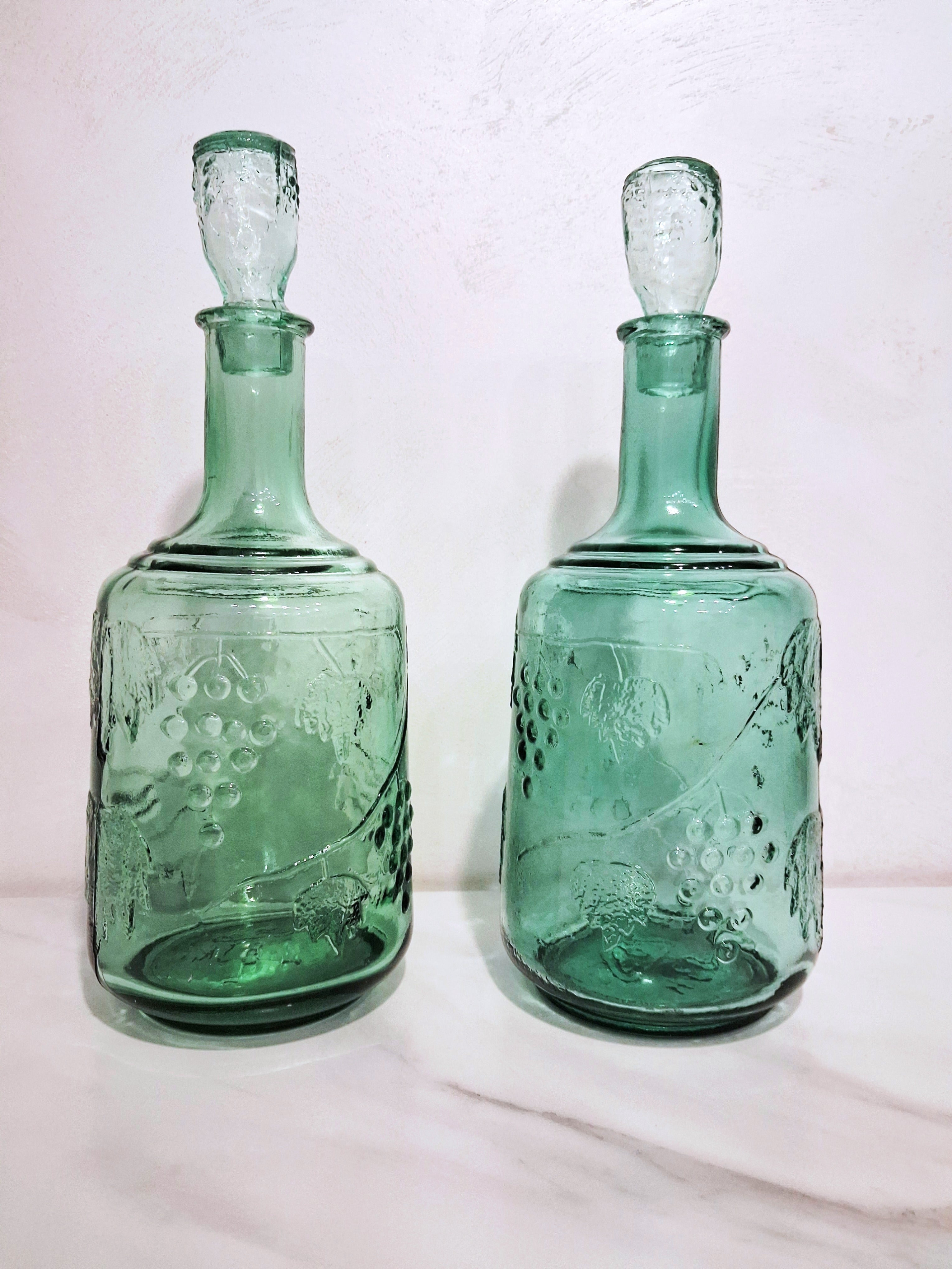 Pair of green glass Decanters with stoppers, Embossed grape motif