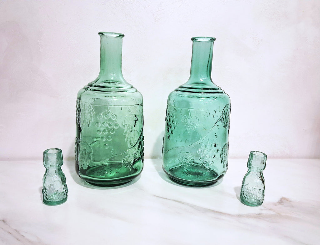 Pair of green glass Decanters with stoppers, Embossed grape motif