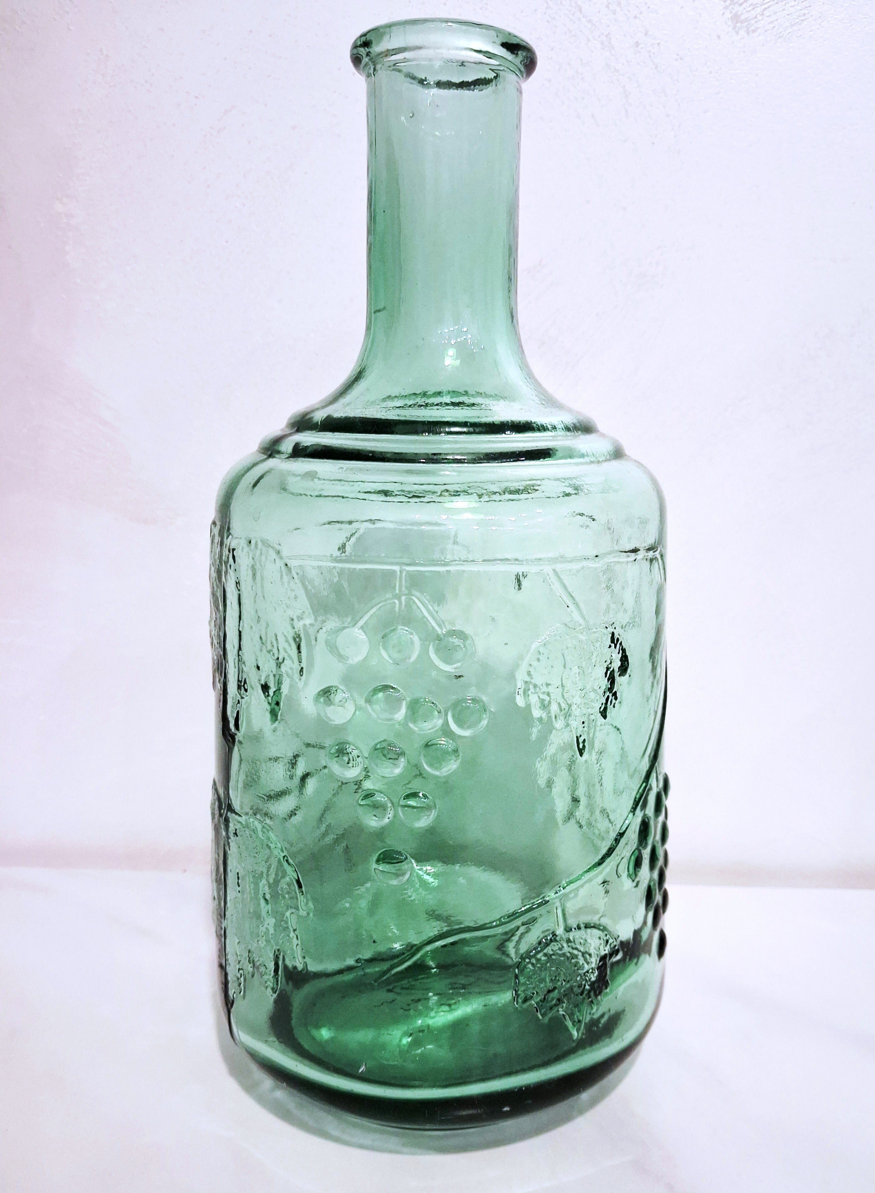 Pair of green glass Decanters with stoppers, Embossed grape motif