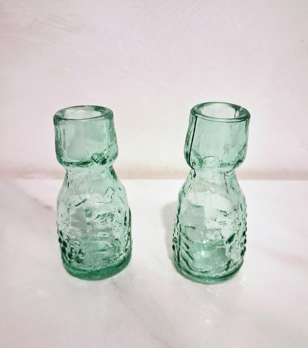 Pair of green glass Decanters with stoppers, Embossed grape motif