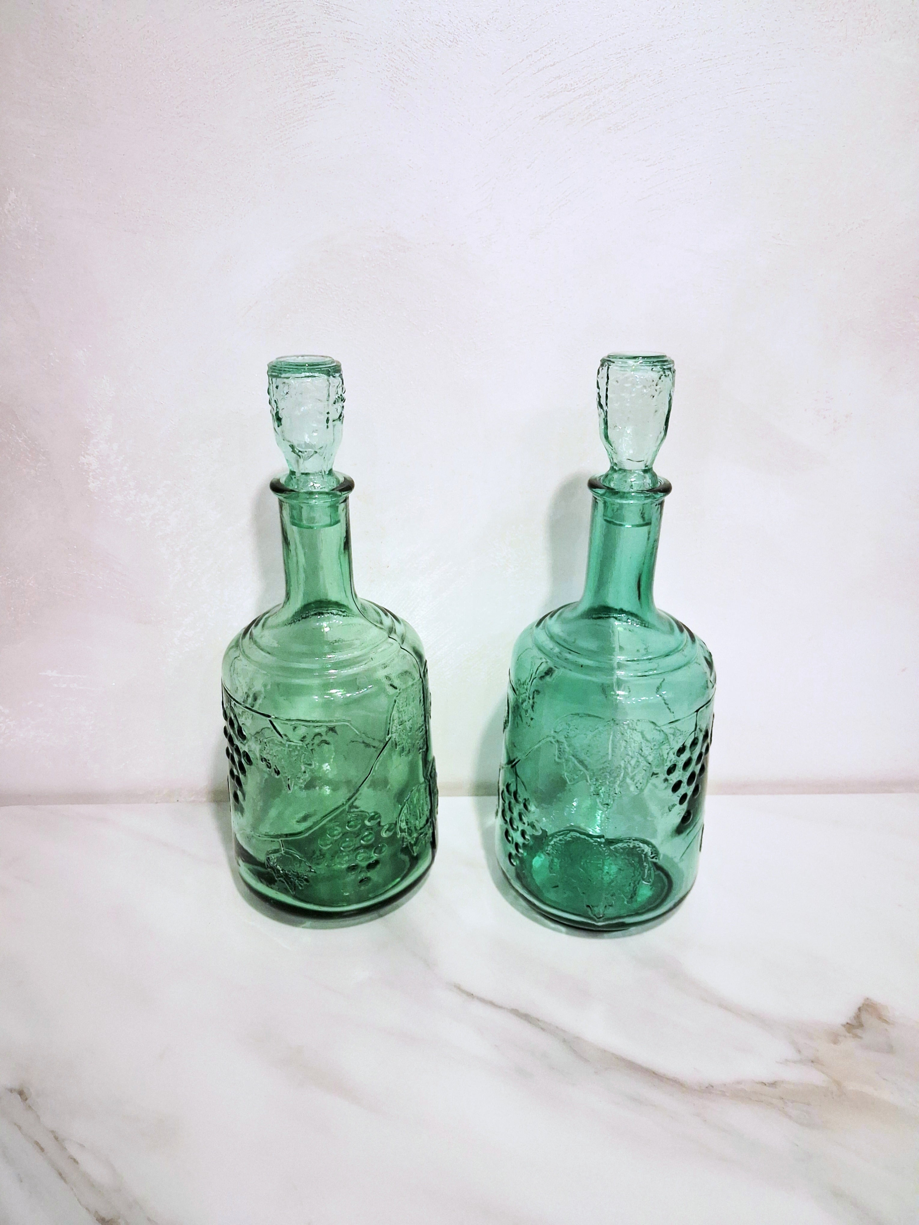 Pair of green glass Decanters with stoppers, Embossed grape motif