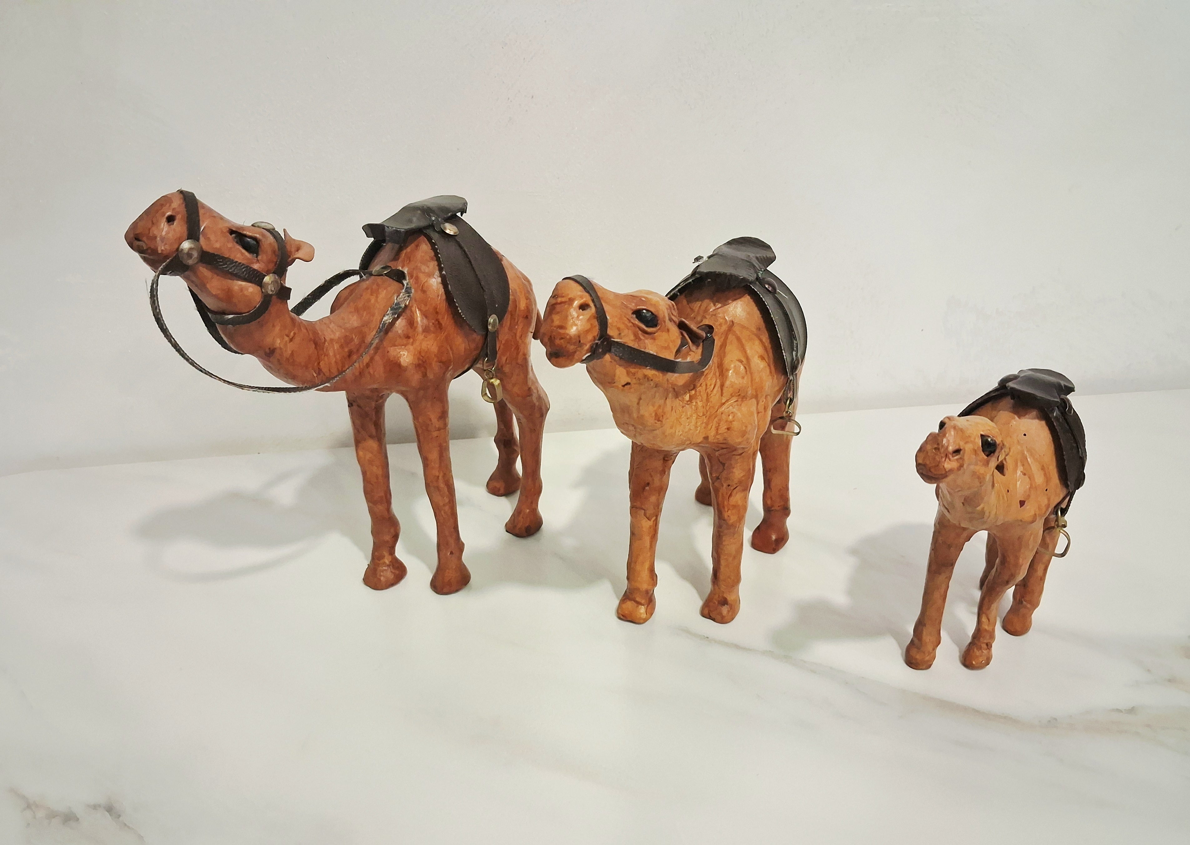 Leather-covered camel figurines set of three