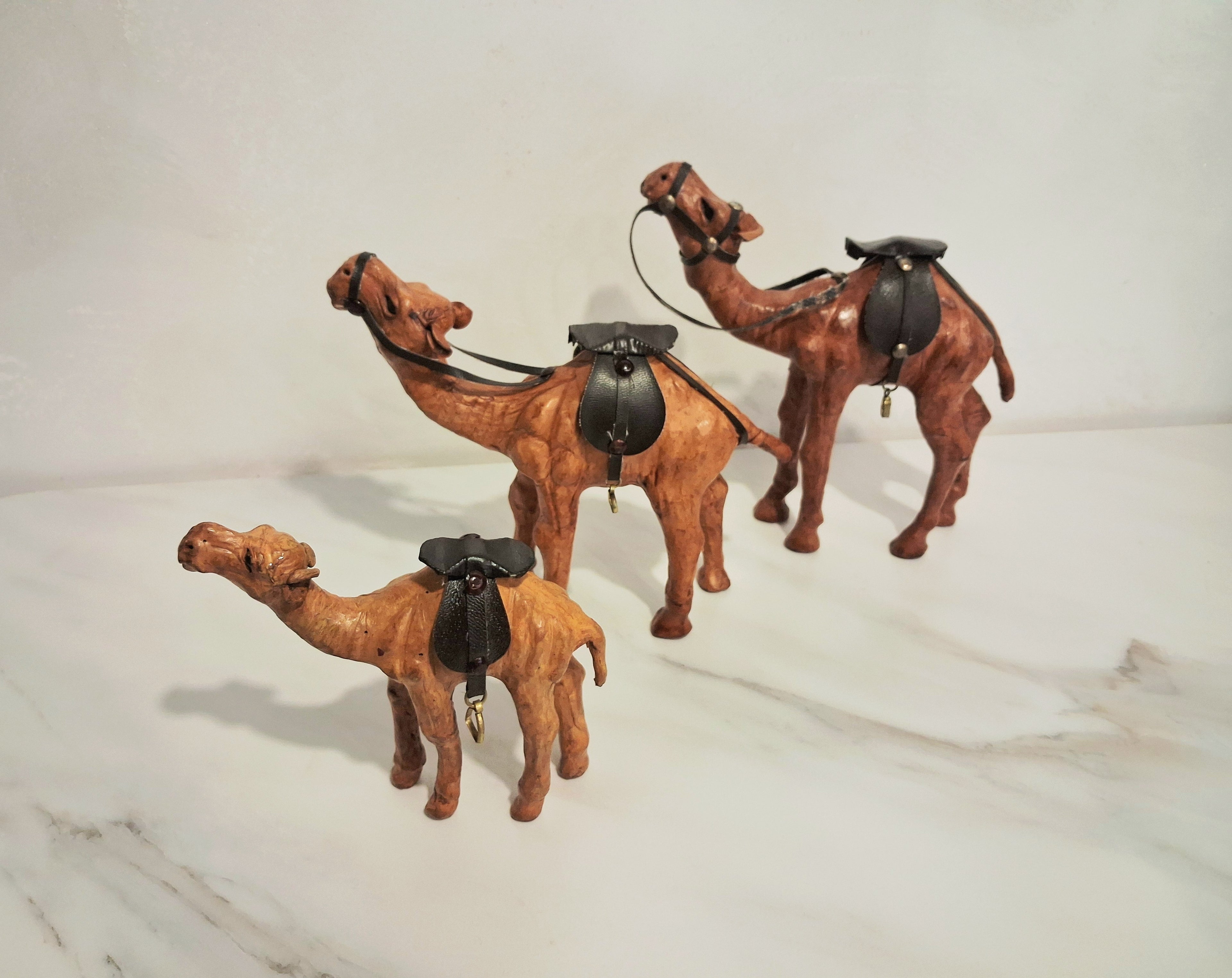 Leather-covered camel figurines set of three