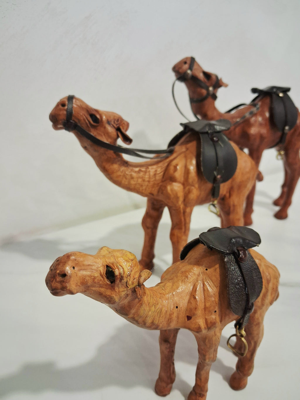 Leather-covered camel figurines set of three