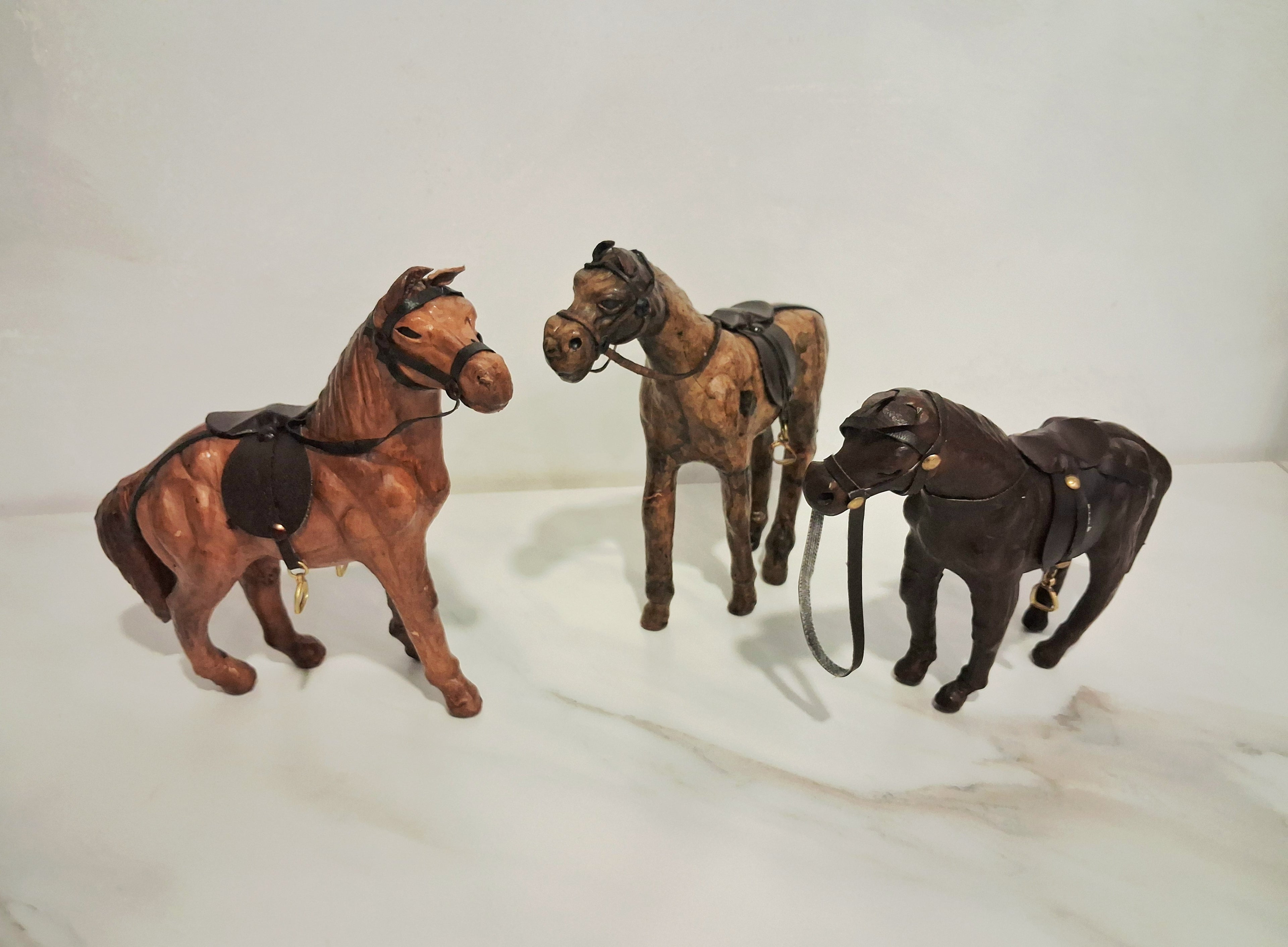Leather-covered horse figurines set of three