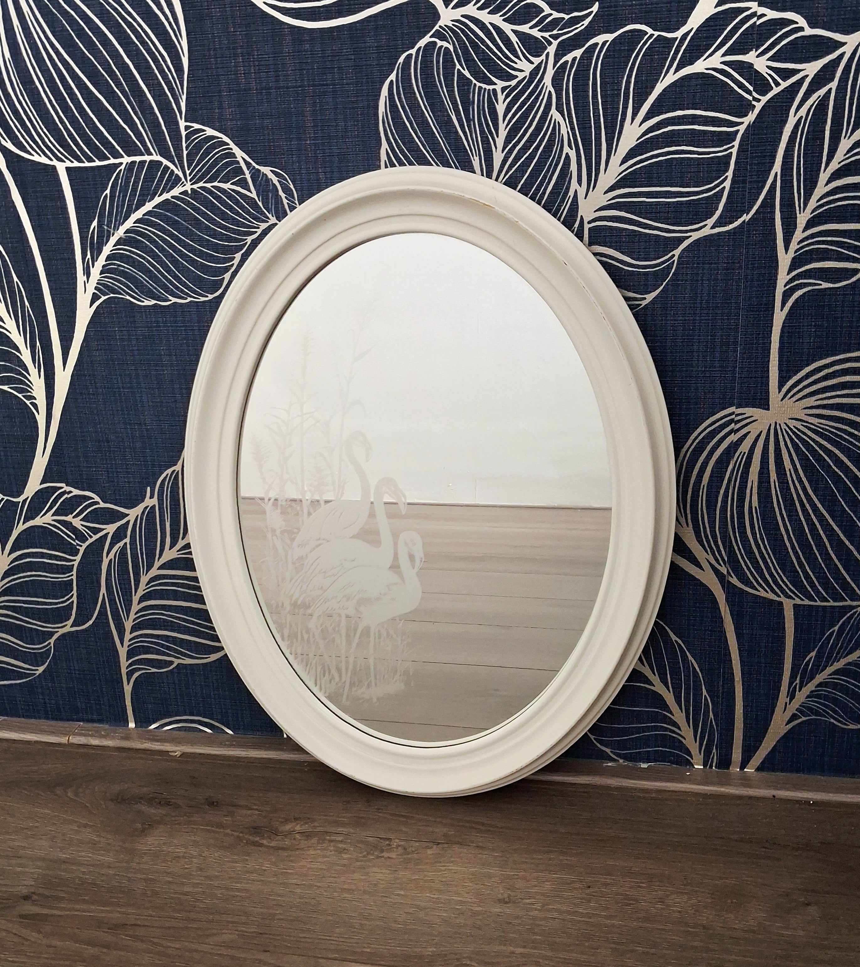 Oval wall mirror with etched flamingos design