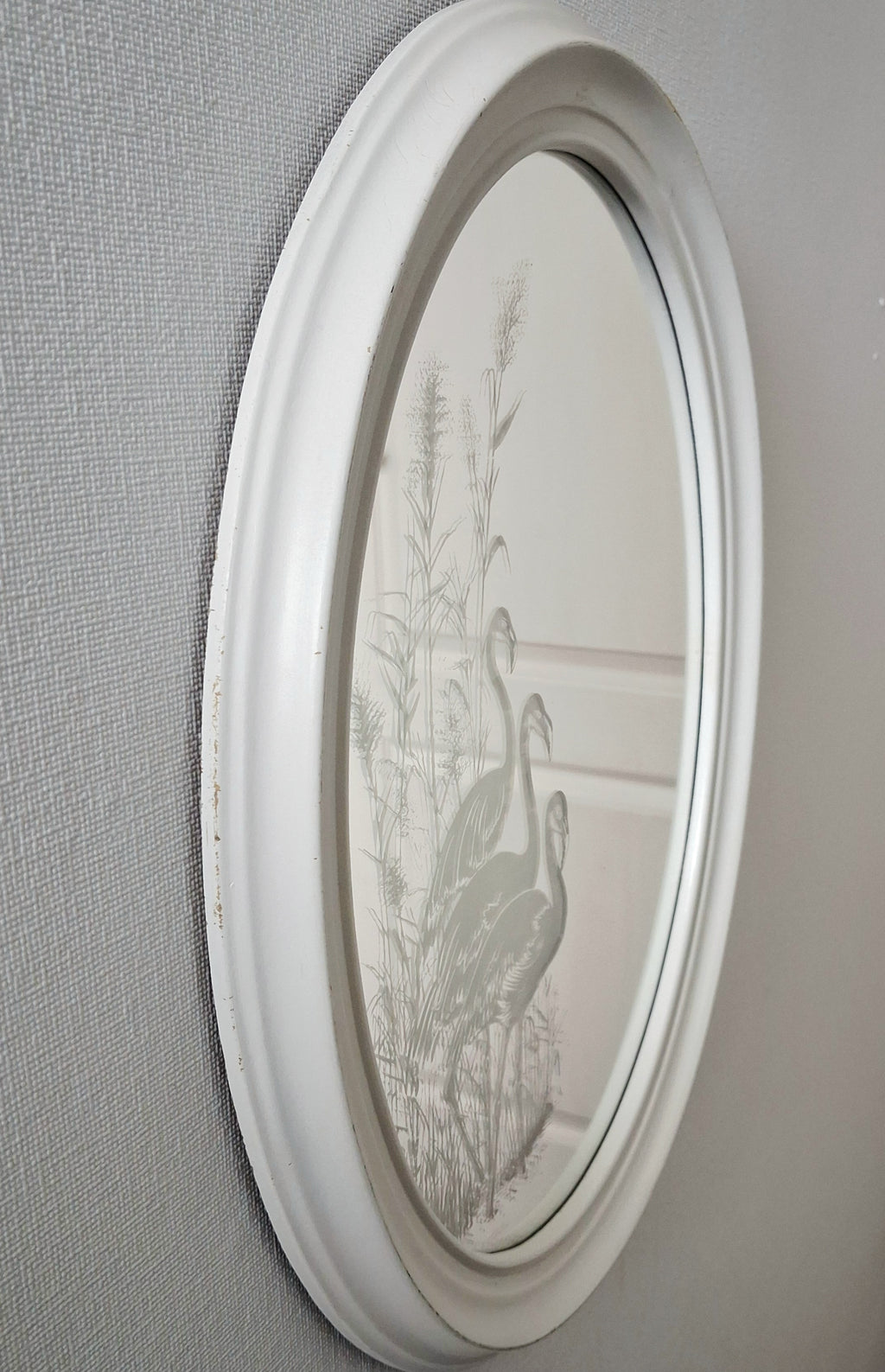 Oval wall mirror with etched flamingos design