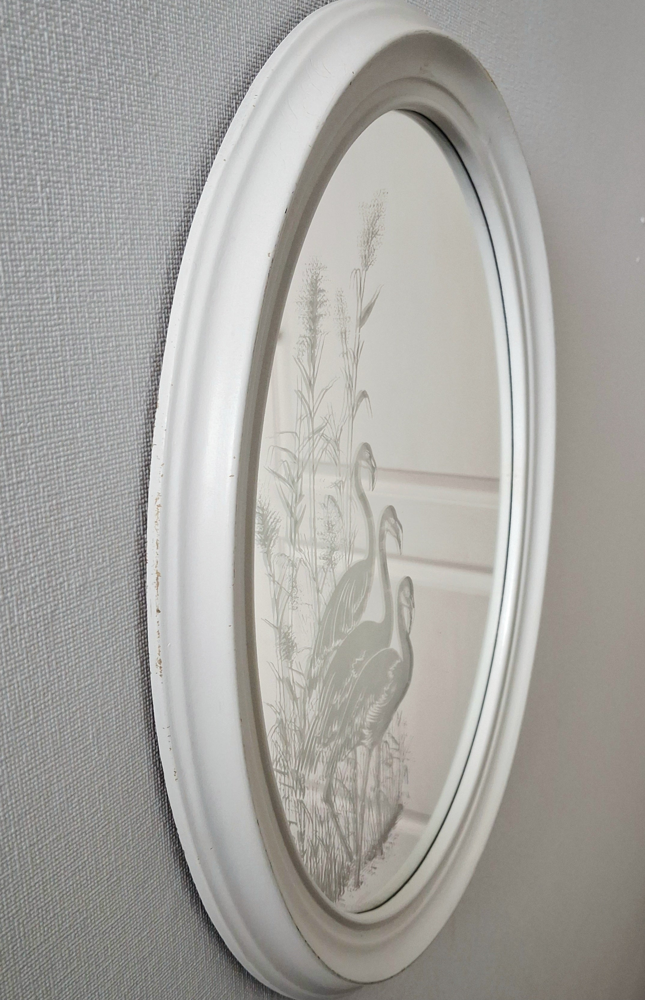 Oval wall mirror with etched flamingos design