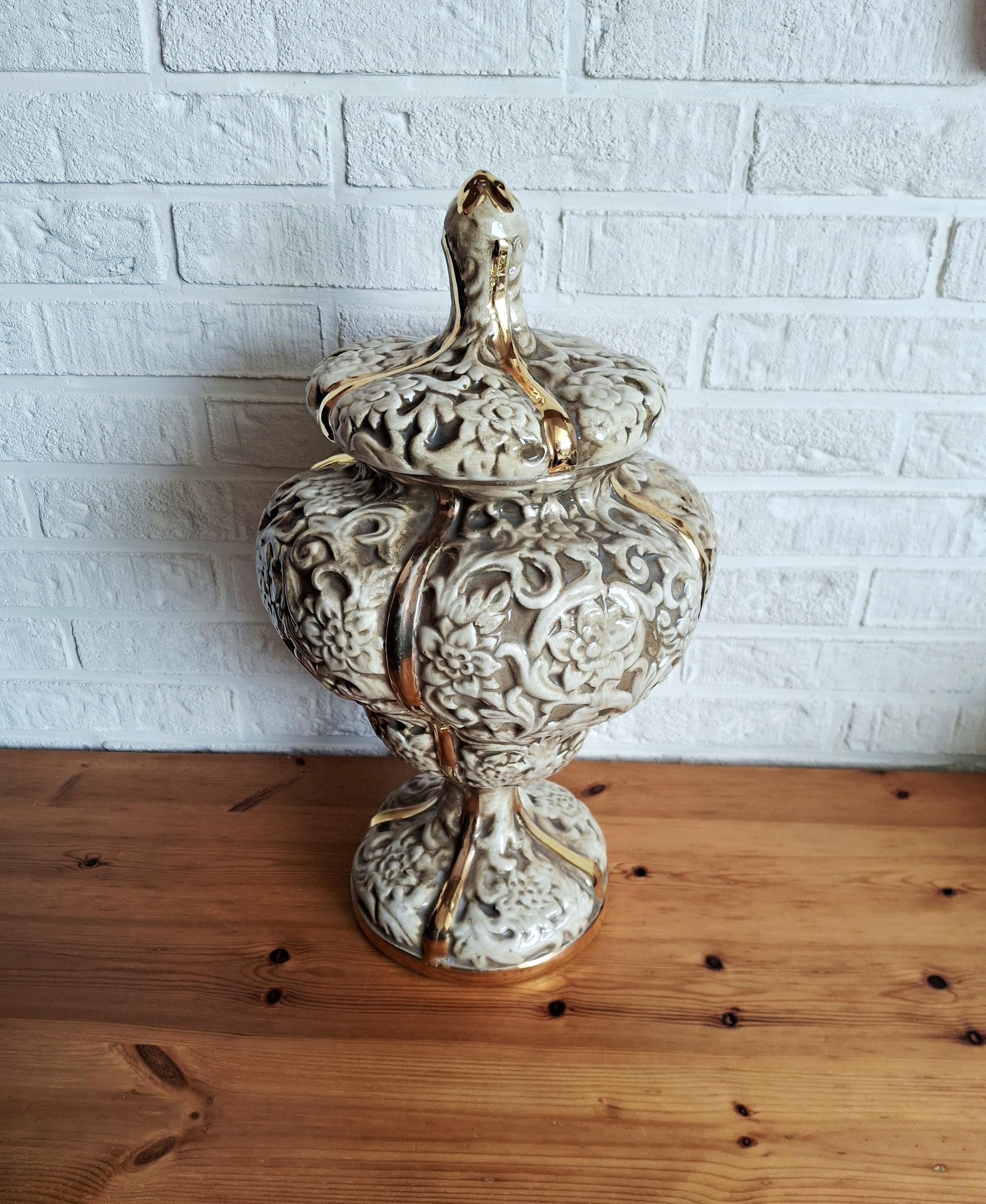 Italian rococo revival lidded vase with floral reliefs and gold accents