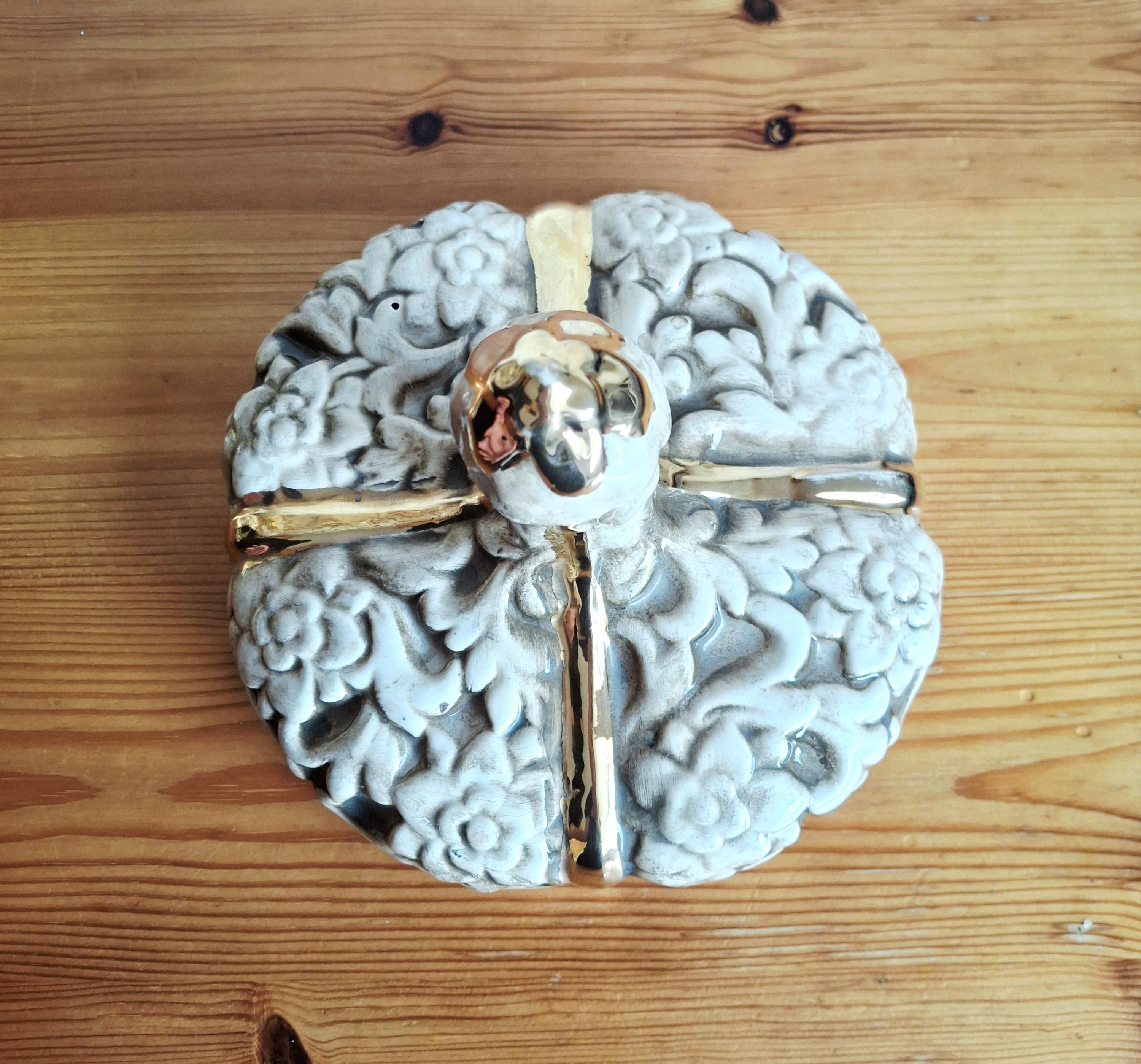 Italian rococo revival lidded vase with floral reliefs and gold accents