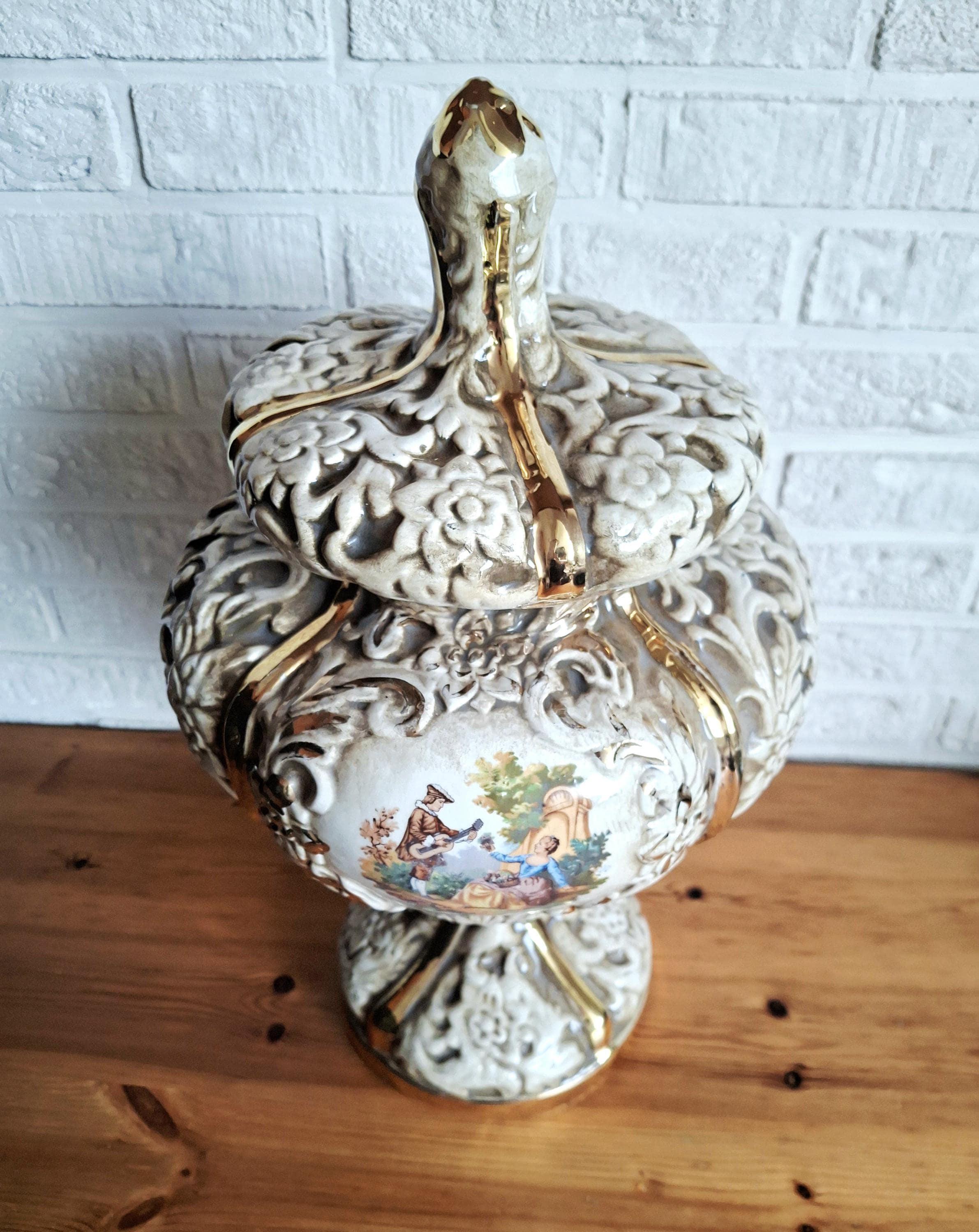 Italian rococo revival lidded vase with floral reliefs and gold accents