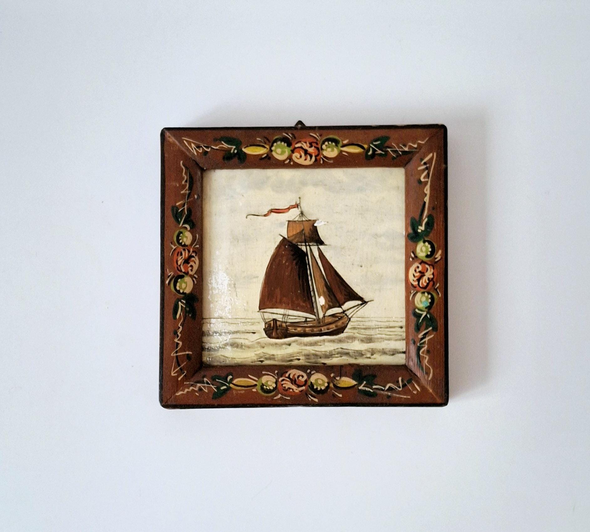 Decorative framed Dutch tile with a sailboat image